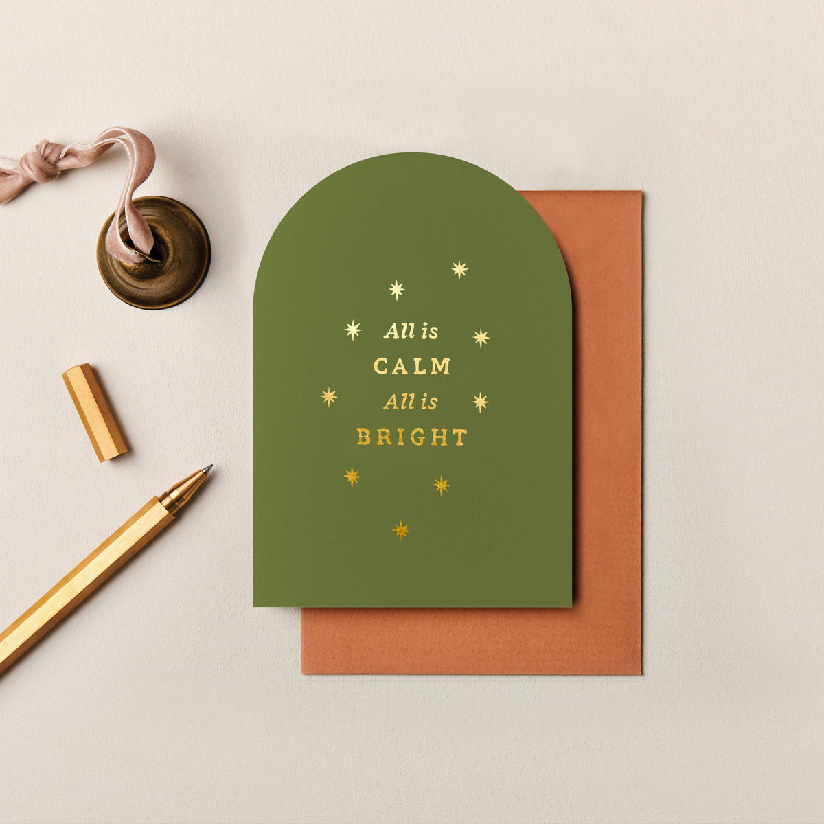 Olive green arched All Is Calm Christmas card with gold foil stars and rust envelope