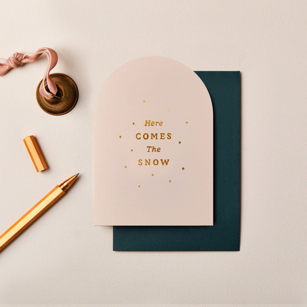 Cream arched Here Comes The Snow Christmas card with gold foil snow details